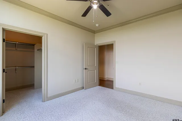 a bathroom with a granite countertop sink a toilet and a mirror