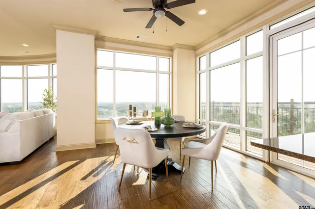 a view of an empty room with wooden floor fireplace and a window