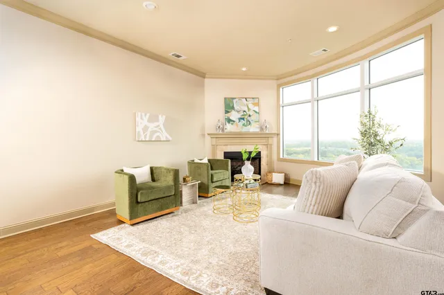 a living room with furniture kitchen view and a chandelier
