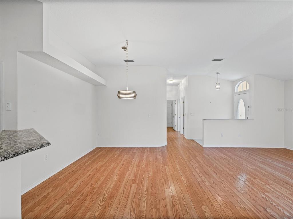 11621 Holly Ann Drive New Port Richey, FL 34654 - Photo 11 of 59 a view of empty room with wooden floor