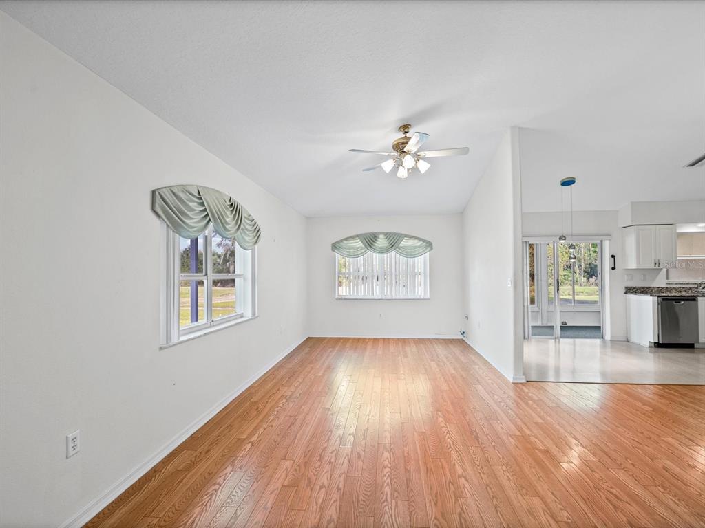 11621 Holly Ann Drive New Port Richey, FL 34654 - Photo 12 of 59 wooden floor in an empty room with a window