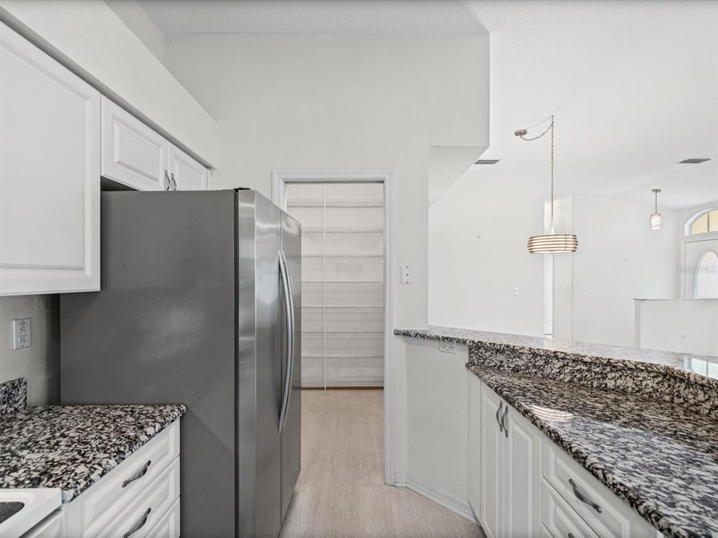 11621 Holly Ann Drive New Port Richey, FL 34654 - Photo 17 of 59 a kitchen with stainless steel appliances granite countertop a refrigerator and a stove