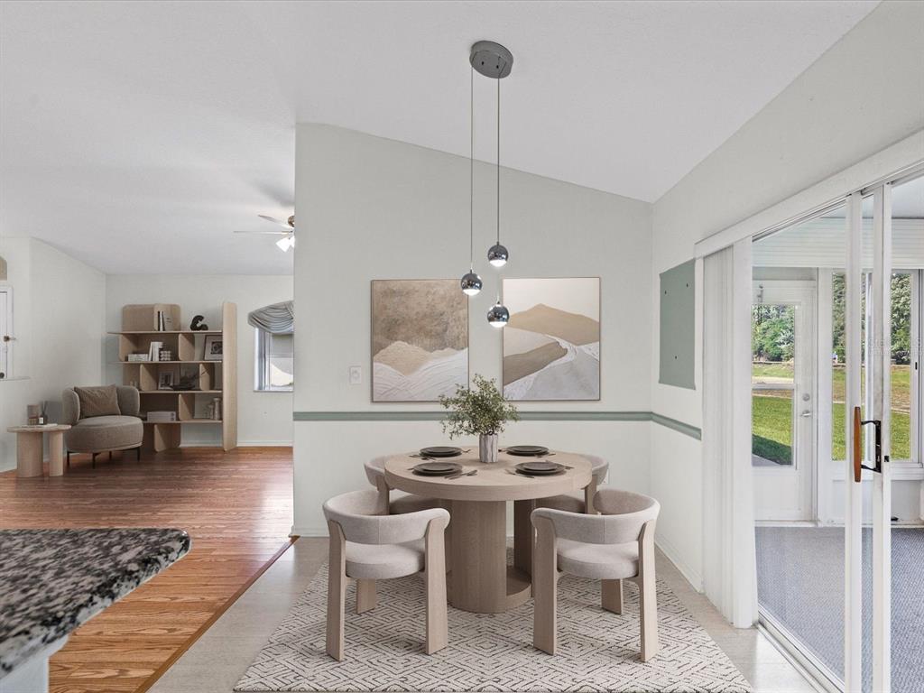 11621 Holly Ann Drive New Port Richey, FL 34654 - Photo 19 of 59 a dining room with furniture a rug and a chandelier