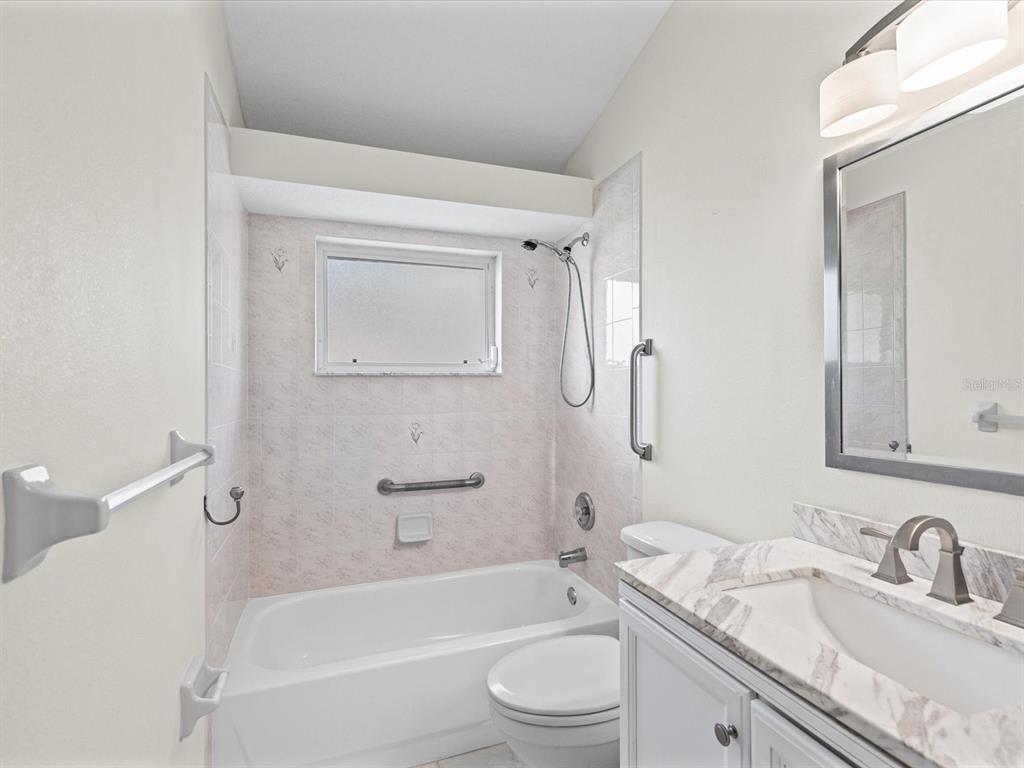 11621 Holly Ann Drive New Port Richey, FL 34654 - Photo 23 of 59 a bathroom with a granite countertop sink toilet tub and shower
