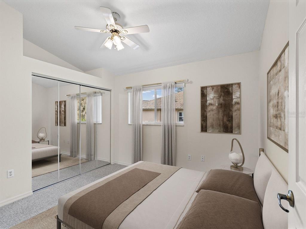 11621 Holly Ann Drive New Port Richey, FL 34654 - Photo 32 of 59 a bedroom with a bed and a chandelier