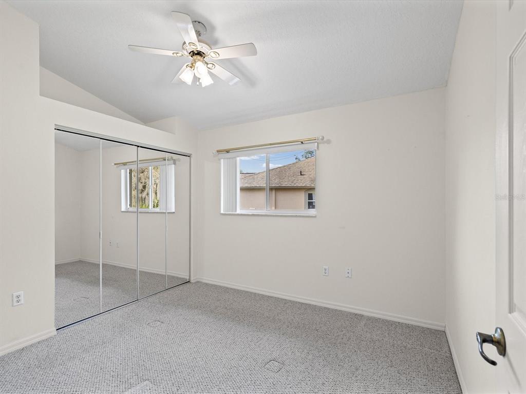 11621 Holly Ann Drive New Port Richey, FL 34654 - Photo 33 of 59 wooden floor in an empty room with a window