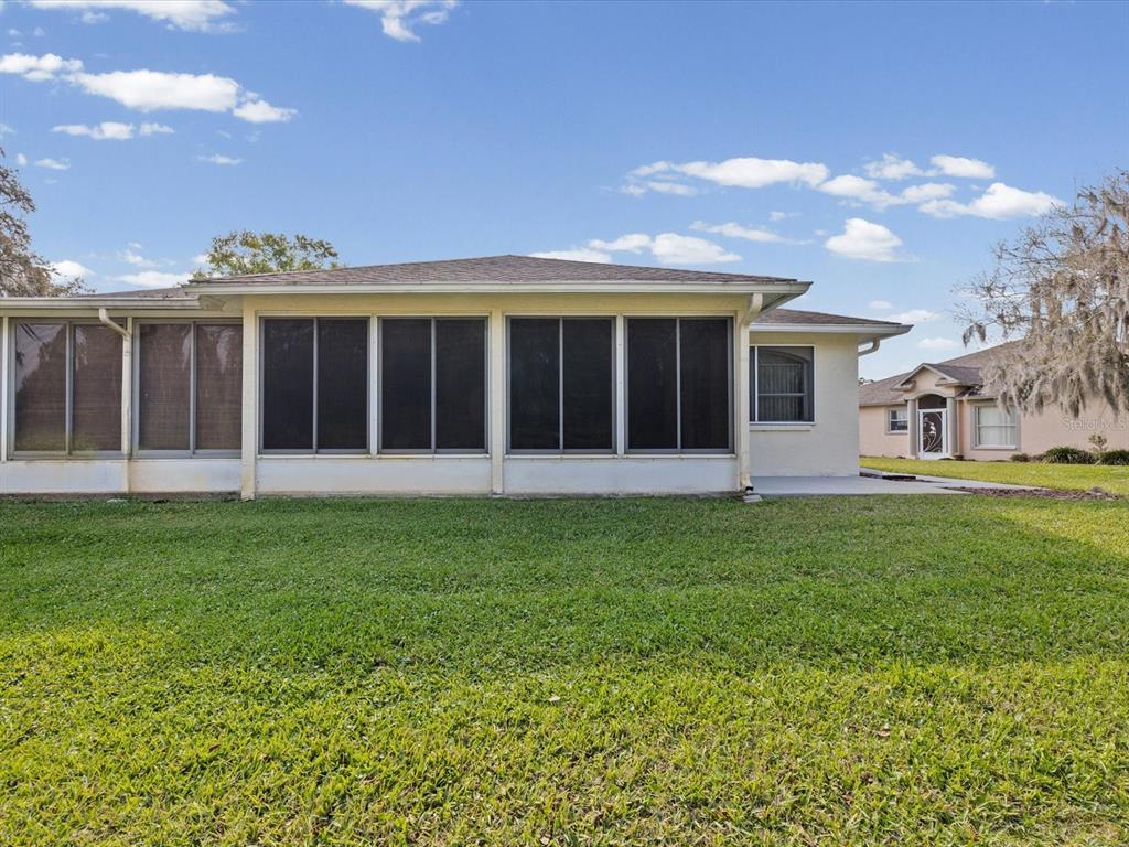 11621 Holly Ann Drive New Port Richey, FL 34654 - Photo 39 of 59 a view of a house with garden and porch