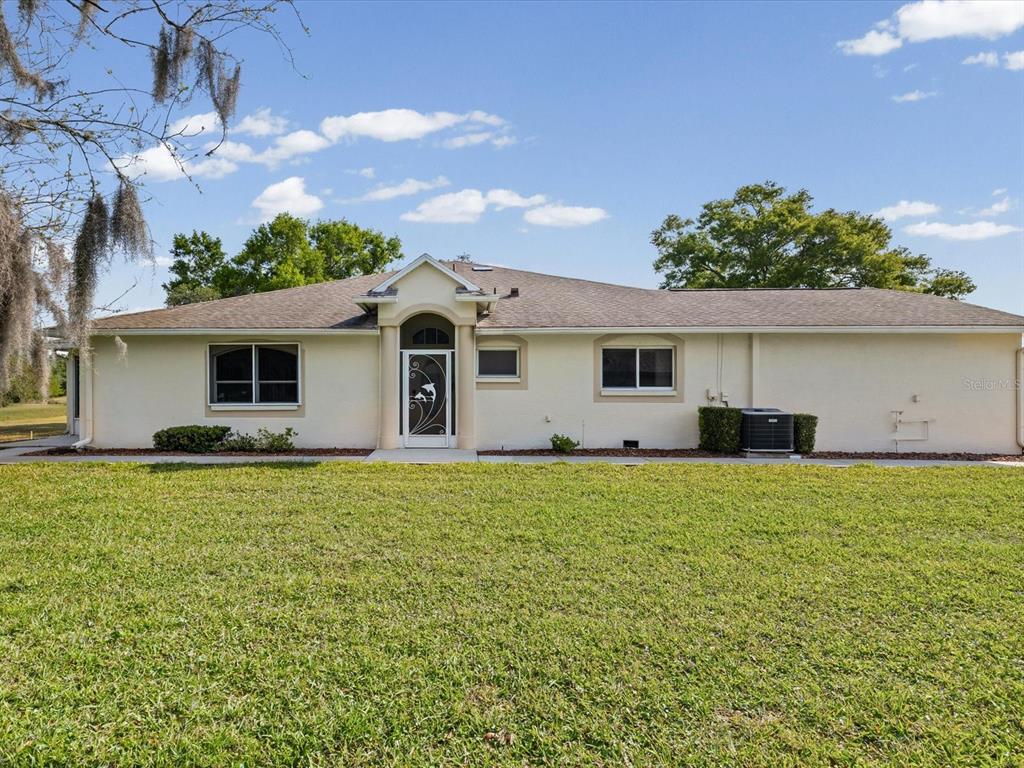 11621 Holly Ann Drive New Port Richey, FL 34654 - Photo 40 of 59 front view of a house with a yard