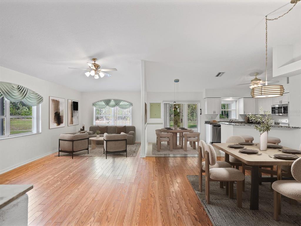 11621 Holly Ann Drive New Port Richey, FL 34654 - Photo 8 of 59 a view of a dining room with furniture wooden floor and chandelier