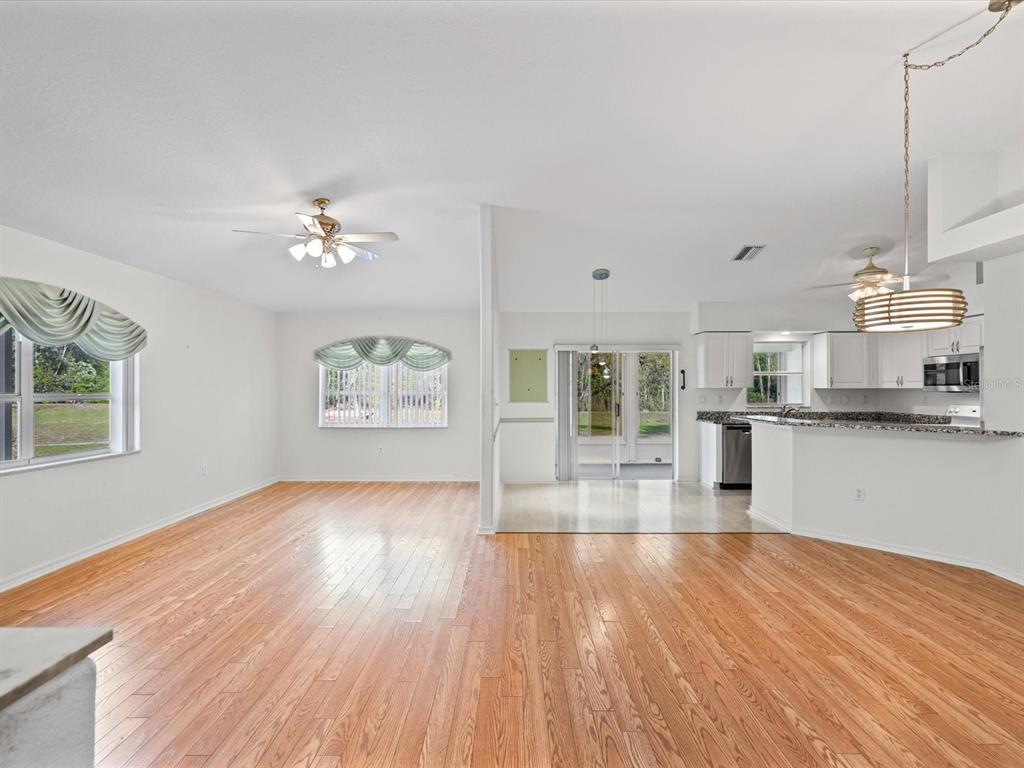 11621 Holly Ann Drive New Port Richey, FL 34654 - Photo 9 of 59 a view of kitchen and hall with wooden floor