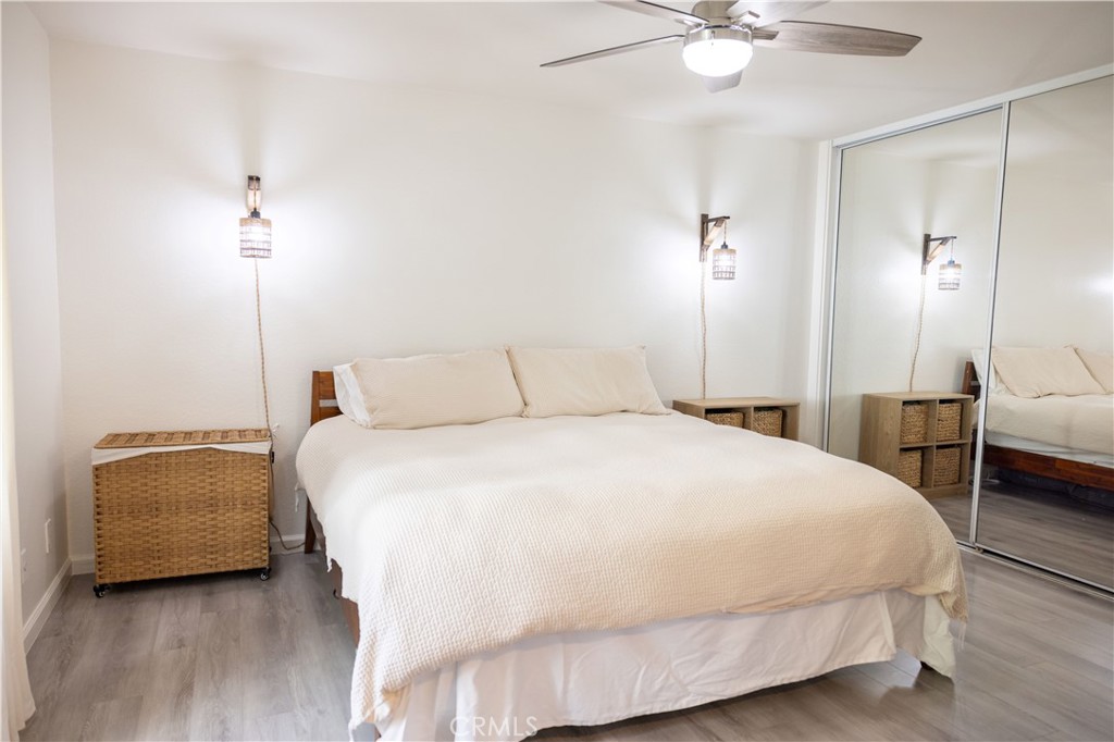 21991-143 Rimhurst Drive Lake Forest, CA 92630 - Photo 11 of 14 a bedroom with a bed and a chandelier