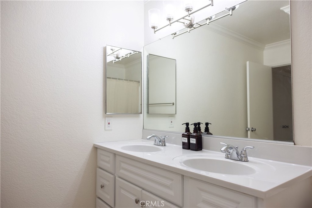 21991-143 Rimhurst Drive Lake Forest, CA 92630 - Photo 5 of 14 a bathroom with a sink and a mirror