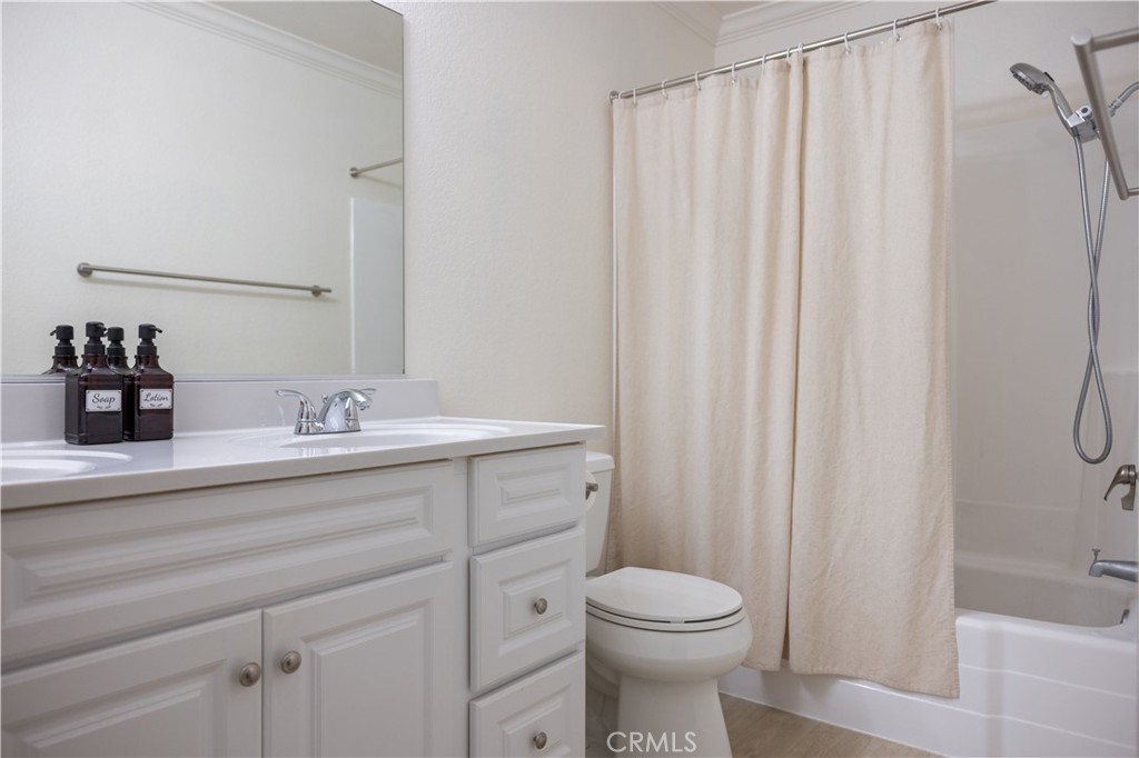 21991-143 Rimhurst Drive Lake Forest, CA 92630 - Photo 8 of 14 a bathroom with a sink a toilet and shower