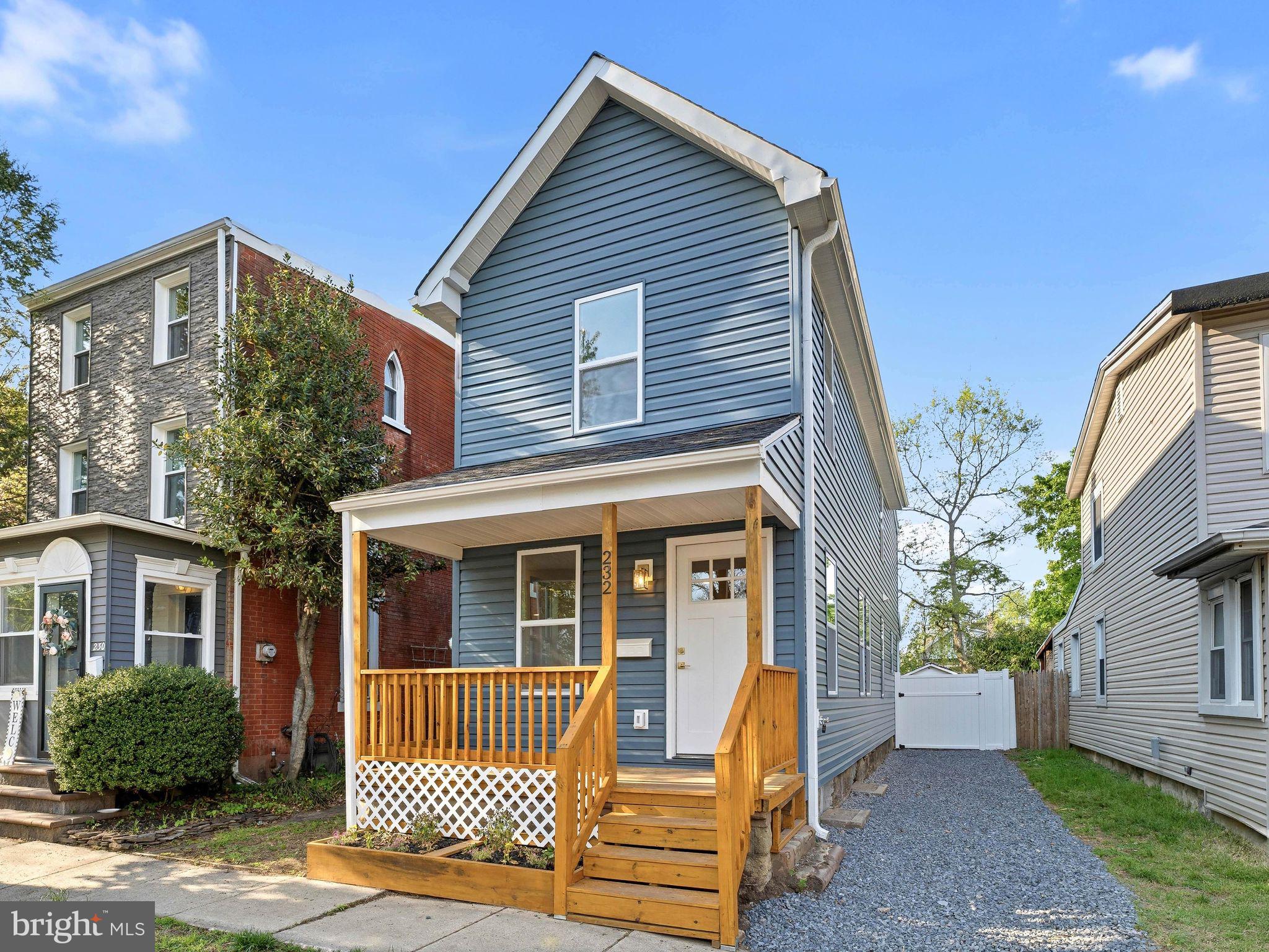 Charming blue home with inviting porch.