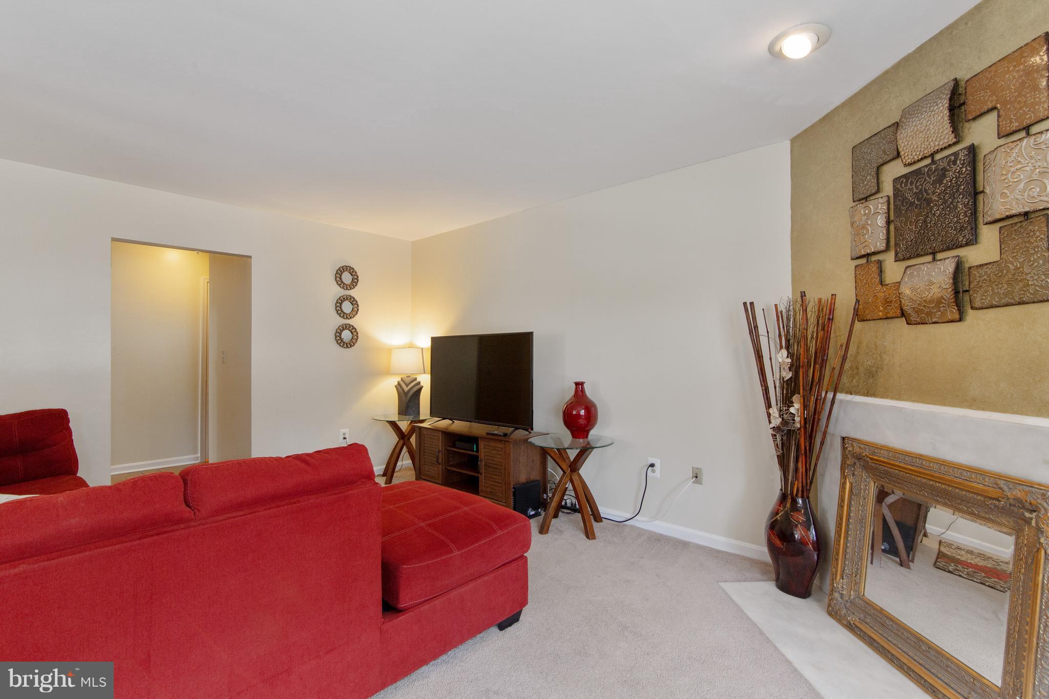 9304 Palmer Place, Unit 5 Laurel, MD 20708 - Photo 7 of 30 a bedroom with furniture and a flat screen tv