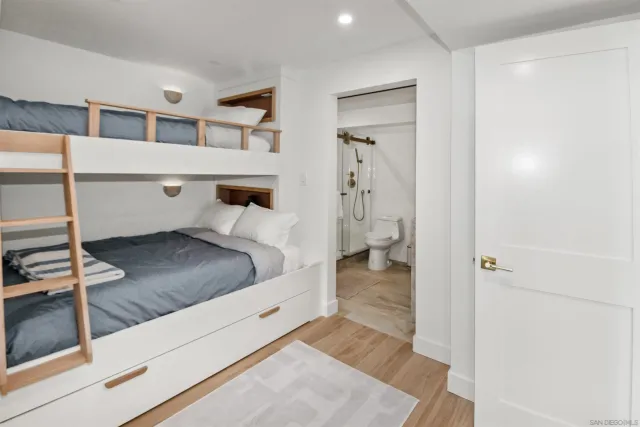 a bedroom with a bed and the view of bathroom