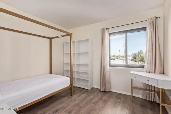 a bedroom with a bed and a window