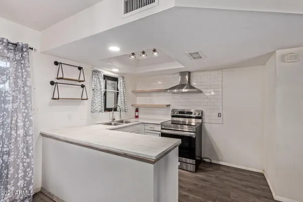 a kitchen with a stove and a sink