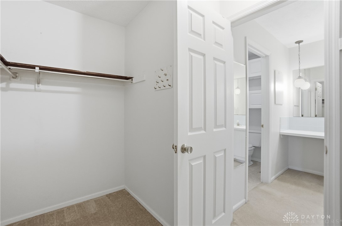 9964 Hummingbird Way Dayton, OH 45458 - Photo 34 of 57 This bright walk-in closet offers ample storage and easy access to an adjacent primary bathroom.