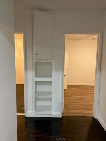 a view of walk in closet with empty room