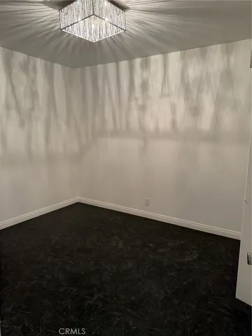 a view of a room with wooden floor and fan