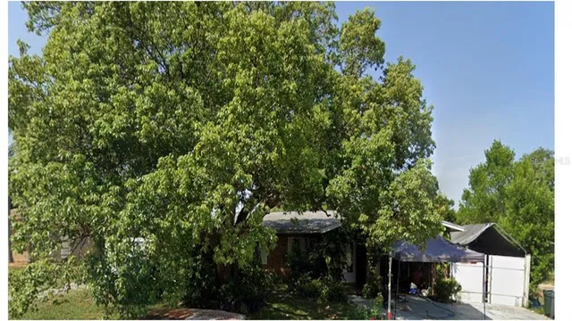 a view of a table and chairs under an umbrella