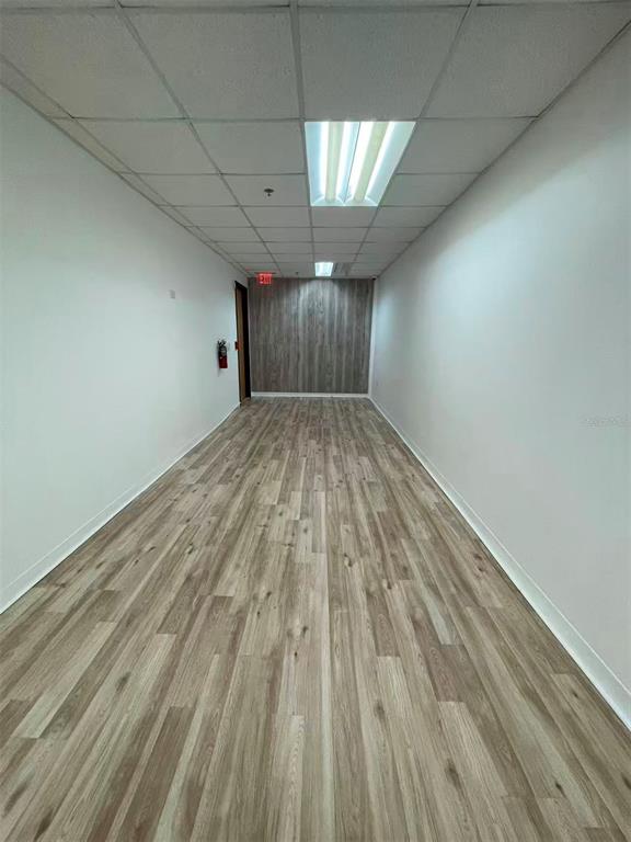 7075 Kingspointe Parkway, Unit 9 Orlando, FL 32819 - Photo 11 of 49 a view of empty room with wooden floor