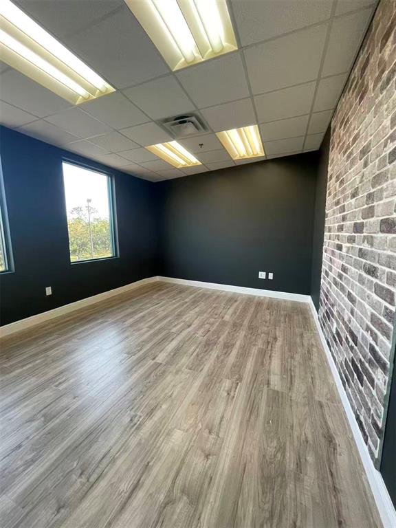7075 Kingspointe Parkway, Unit 9 Orlando, FL 32819 - Photo 16 of 49 a view of empty room with window and wooden floor