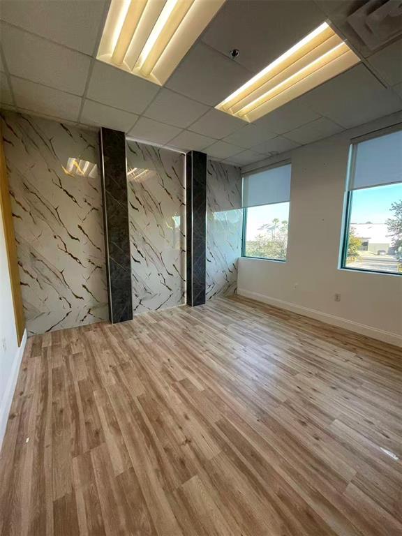 7075 Kingspointe Parkway, Unit 9 Orlando, FL 32819 - Photo 19 of 49 a view of empty room with window and wooden floor