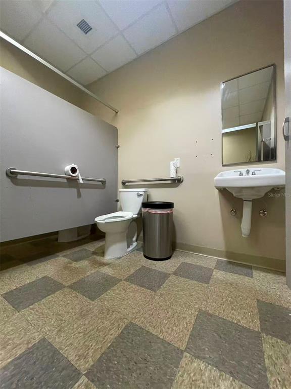 7075 Kingspointe Parkway, Unit 9 Orlando, FL 32819 - Photo 29 of 49 a view of a bathroom with a sink and toilet