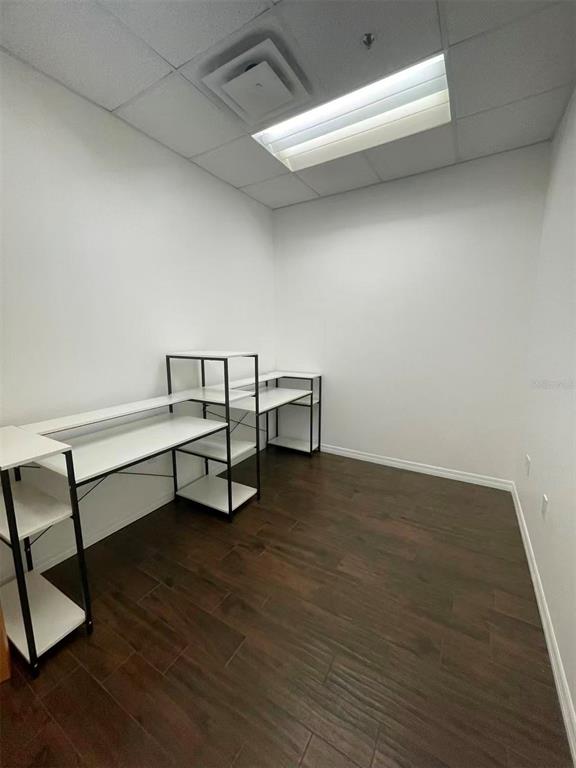 7075 Kingspointe Parkway, Unit 9 Orlando, FL 32819 - Photo 39 of 49 a view of a room with wooden floor and furniture