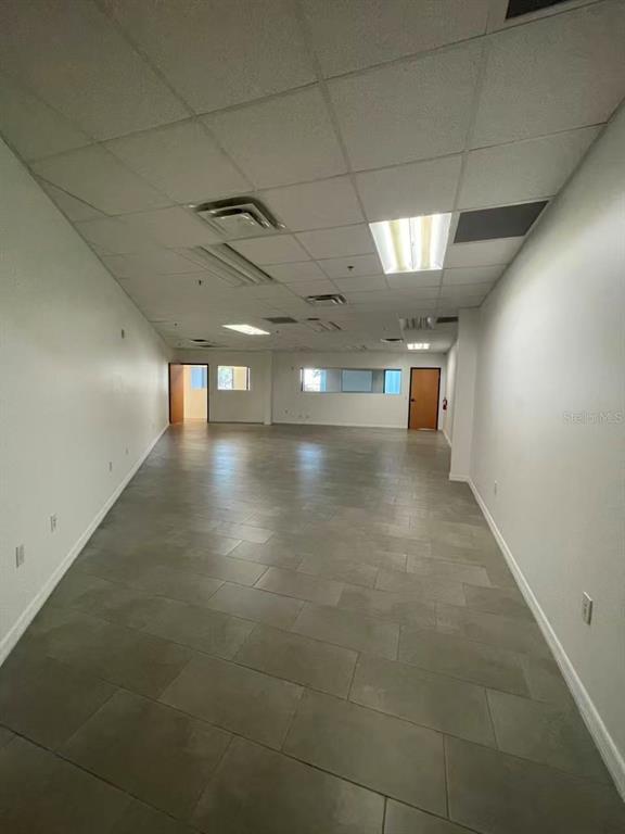 7075 Kingspointe Parkway, Unit 9 Orlando, FL 32819 - Photo 41 of 49 a view of a hallway with wooden floor