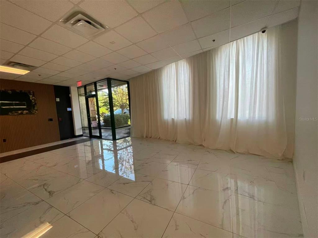 7075 Kingspointe Parkway, Unit 9 Orlando, FL 32819 - Photo 5 of 49 a view of an empty room and window