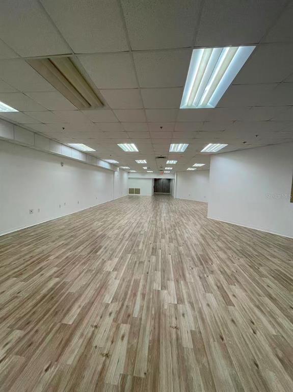 7075 Kingspointe Parkway, Unit 9 Orlando, FL 32819 - Photo 10 of 49 a view of a room with wooden floor