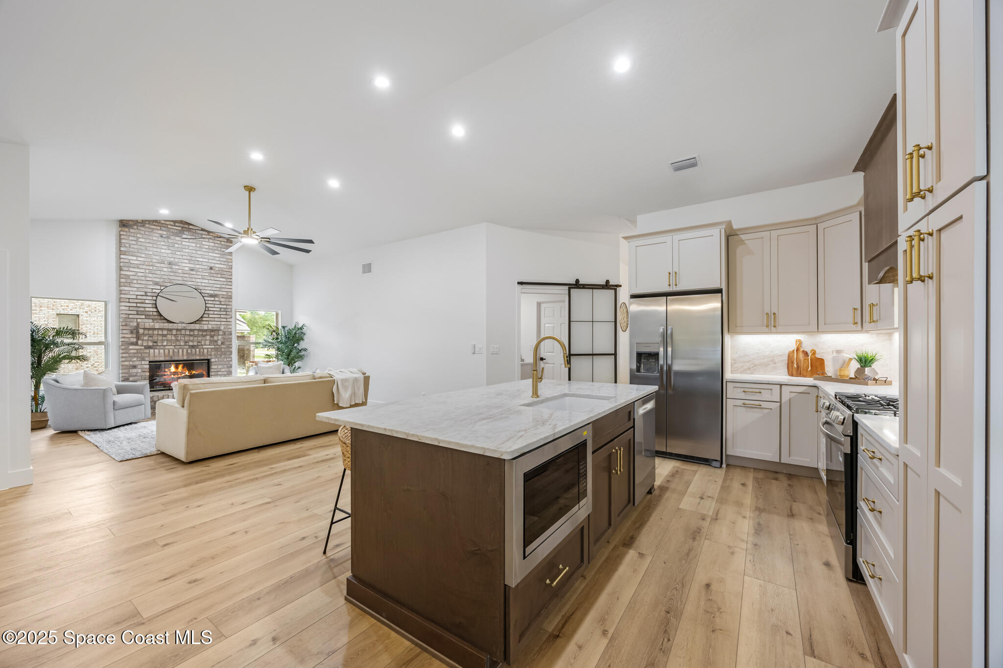 4737 Canard Road Melbourne, FL 32934 - Photo 14 of 35 a kitchen with a center island appliances wooden floor cabinets and a window