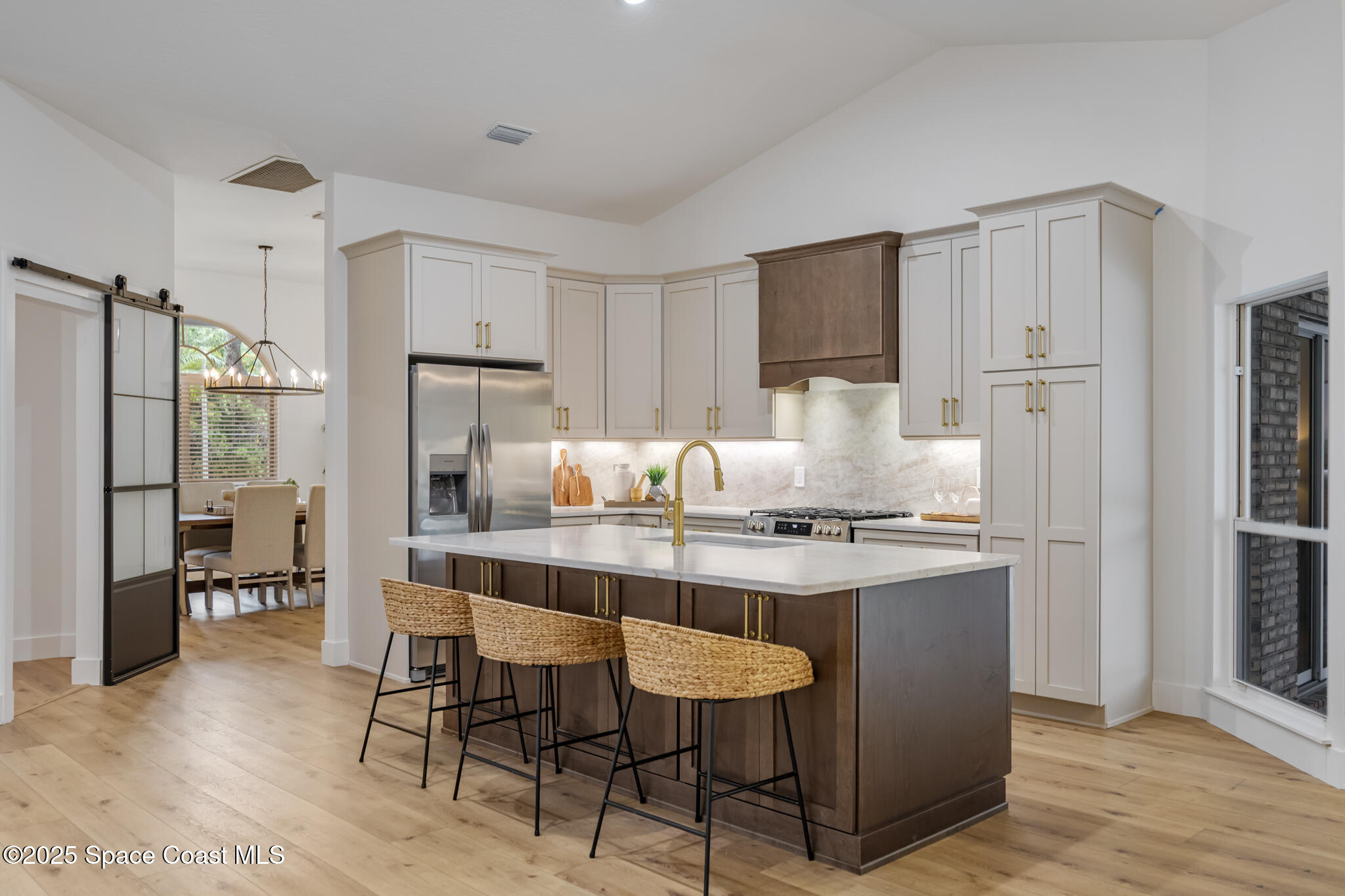 4737 Canard Road Melbourne, FL 32934 - Photo 15 of 35 a kitchen with kitchen island granite countertop a sink cabinets and refrigerator