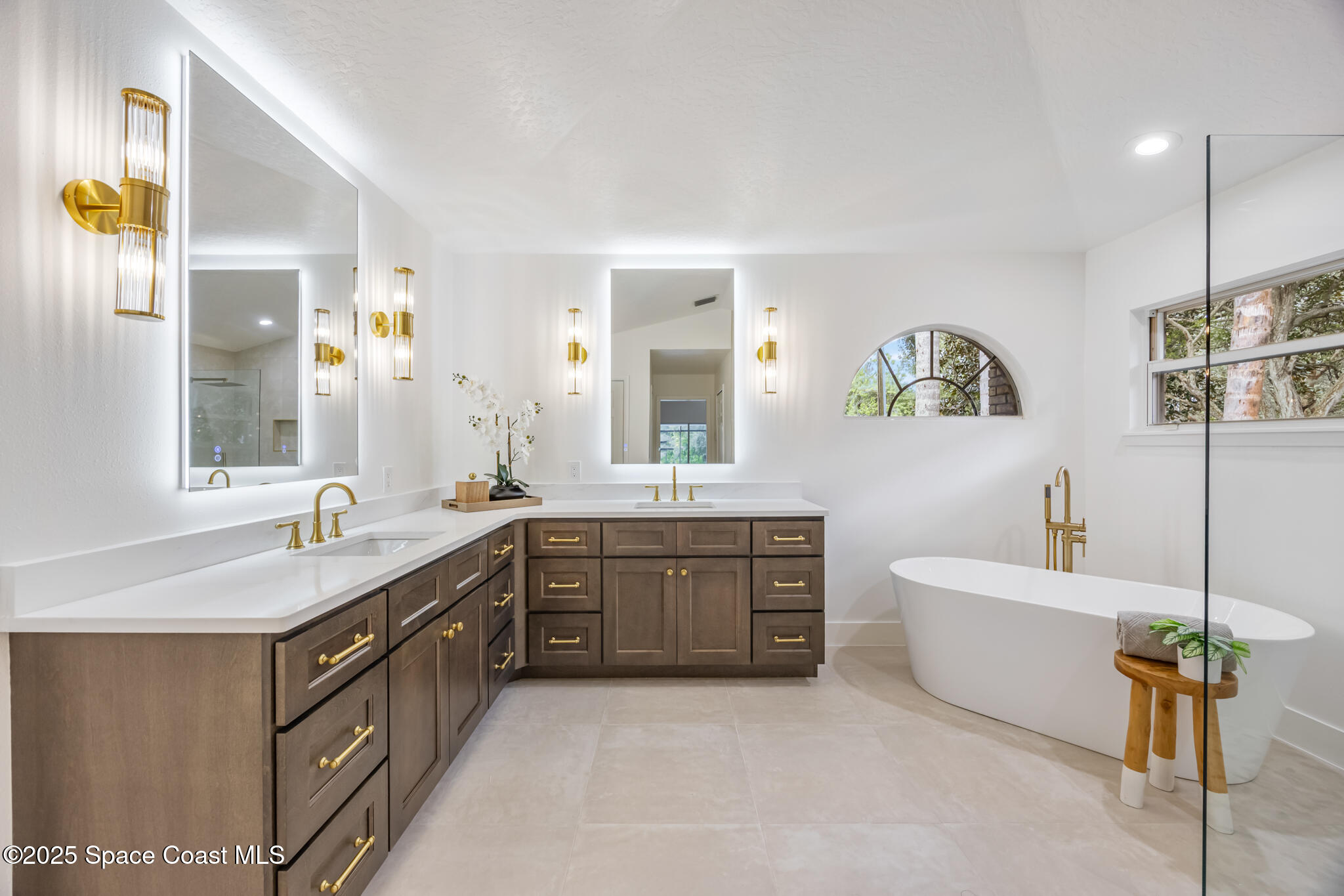 4737 Canard Road Melbourne, FL 32934 - Photo 23 of 35 a spacious bathroom with a granite countertop double vanity sink a mirror and a bathtub