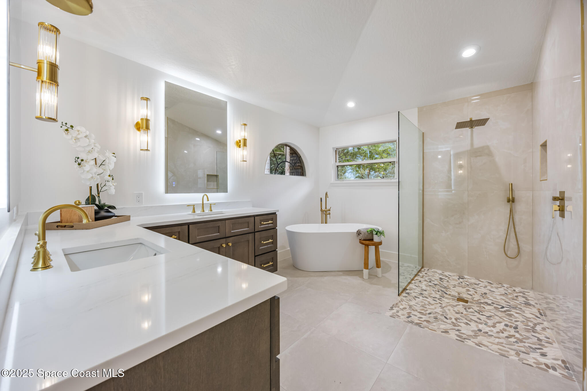 4737 Canard Road Melbourne, FL 32934 - Photo 24 of 35 a spacious bathroom with a tub sink and mirror