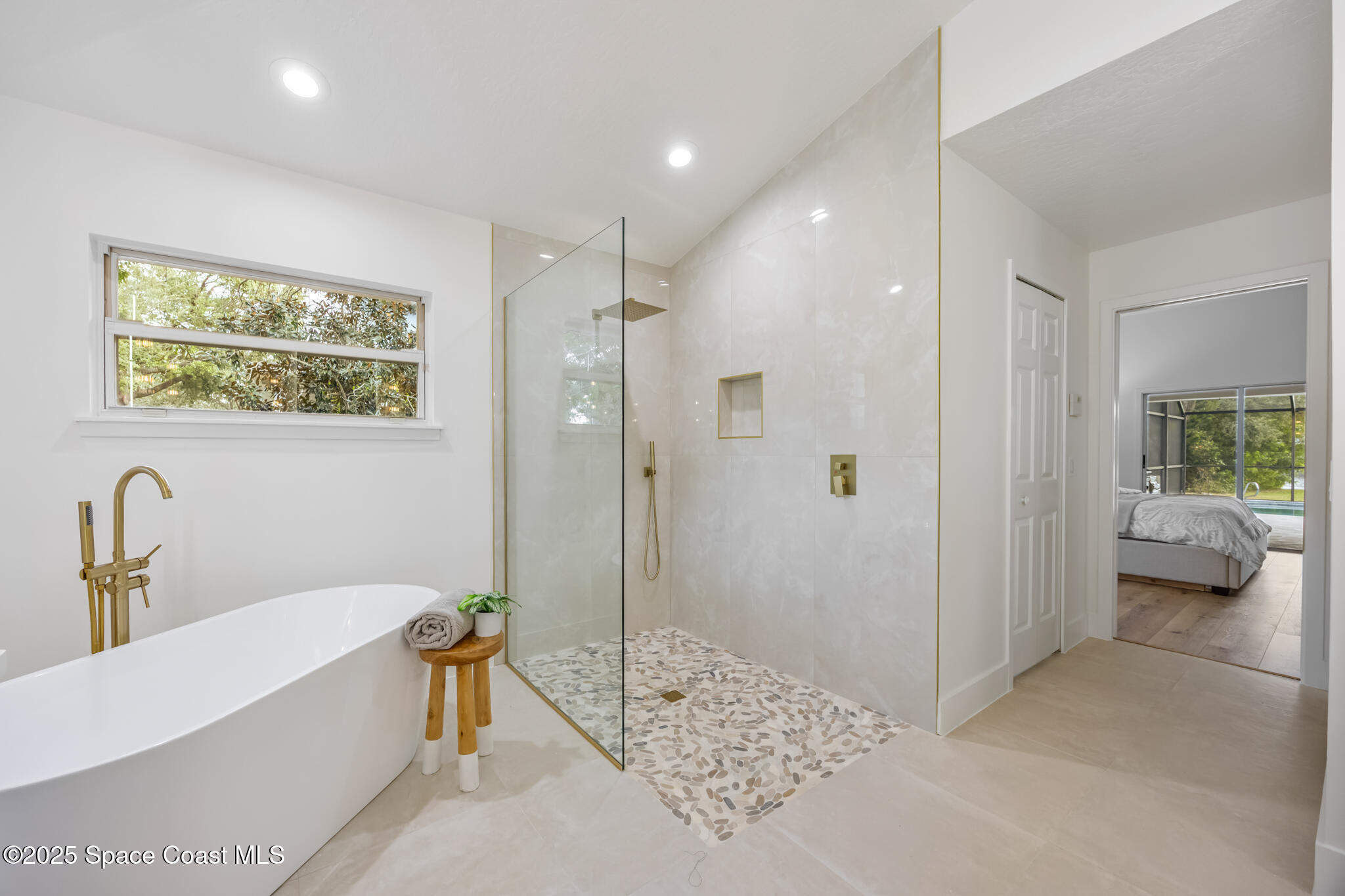 4737 Canard Road Melbourne, FL 32934 - Photo 25 of 35 a bathroom with a tub and shower