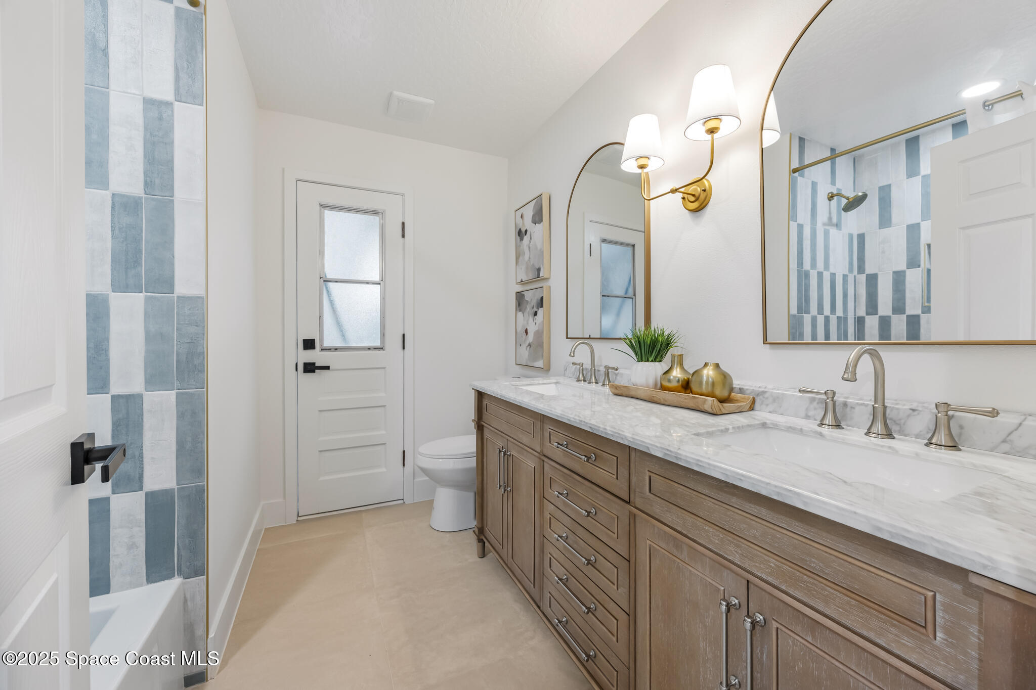 4737 Canard Road Melbourne, FL 32934 - Photo 28 of 35 a spacious bathroom with a granite countertop sink a toilet and a mirror