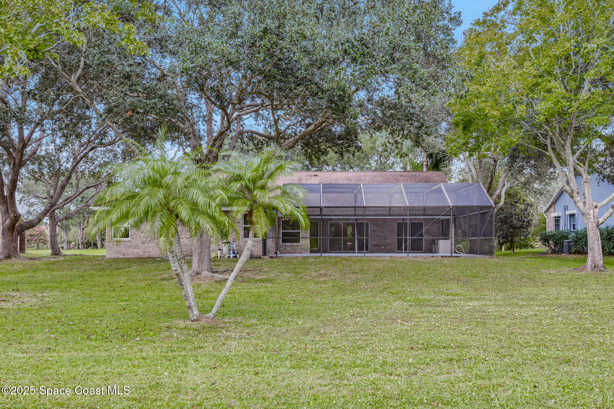 4737 Canard Road Melbourne, FL 32934 - Photo 34 of 35 a house that has a tree in front of a house