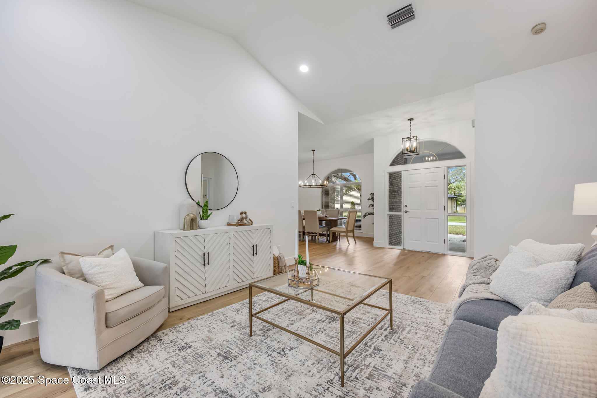 4737 Canard Road Melbourne, FL 32934 - Photo 6 of 35 a living room with furniture a table and a chandelier