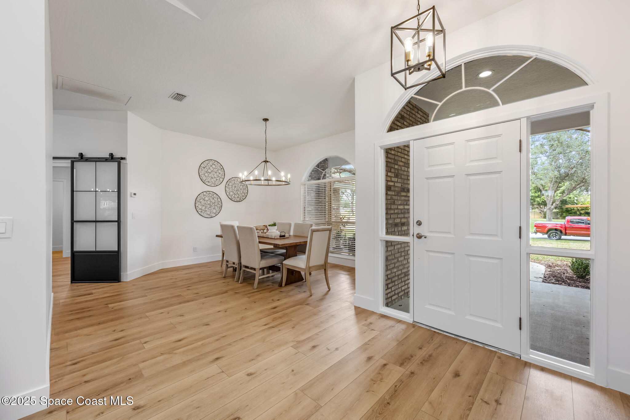 4737 Canard Road Melbourne, FL 32934 - Photo 7 of 35 a view of a livingroom with furniture and wooden floor