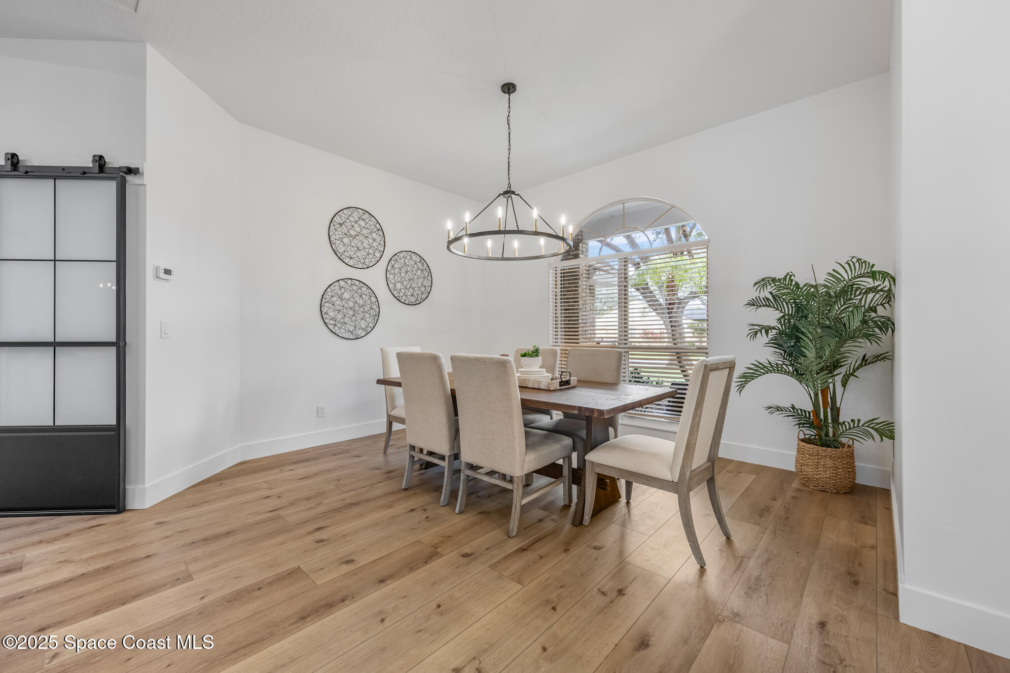 4737 Canard Road Melbourne, FL 32934 - Photo 8 of 35 a view of a dining room with furniture window and wooden floor
