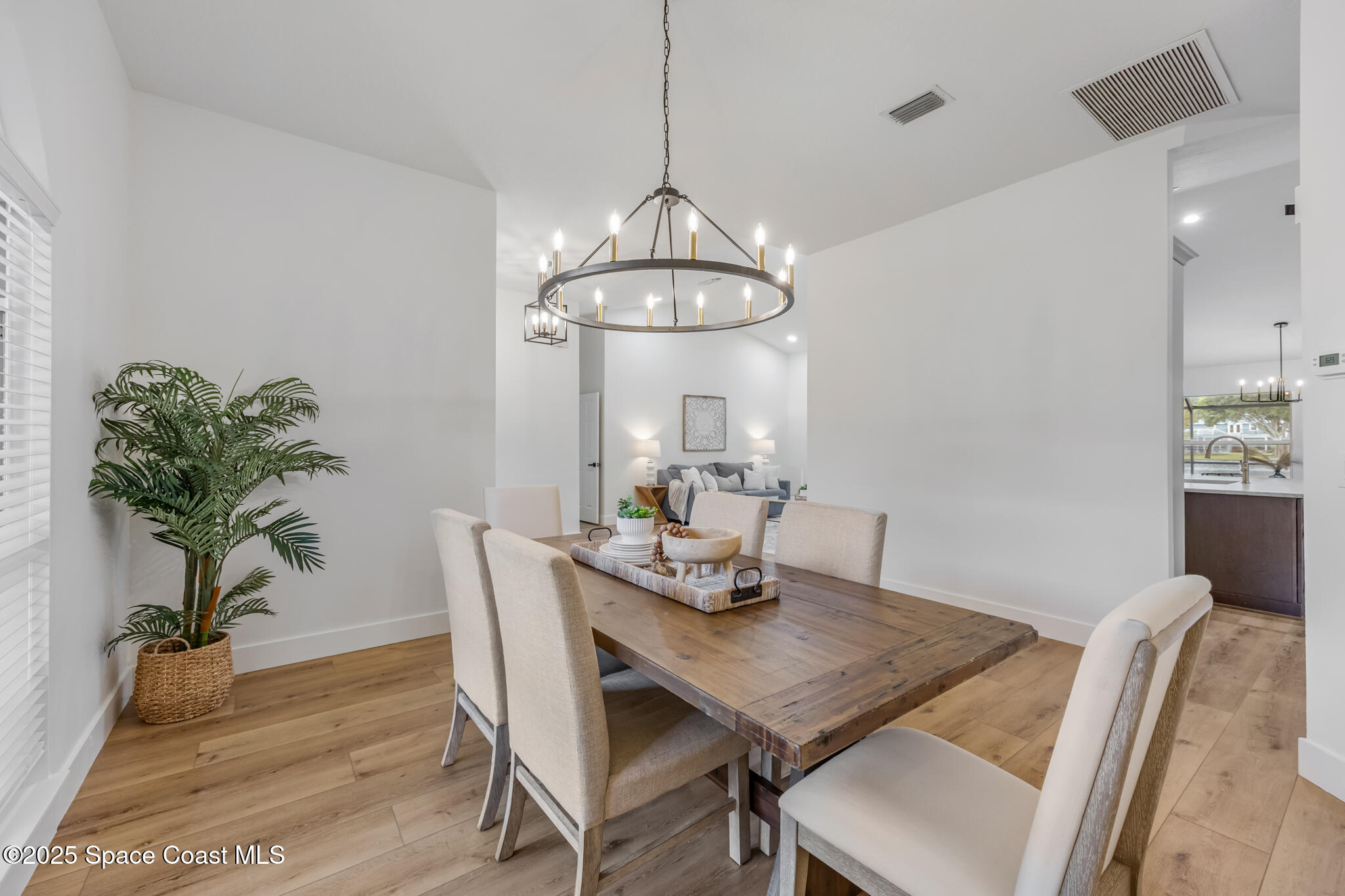 4737 Canard Road Melbourne, FL 32934 - Photo 9 of 35 a view of a dining room with furniture wooden floor and chandelier