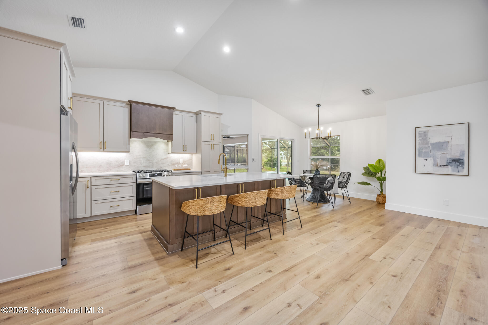 4737 Canard Road Melbourne, FL 32934 - Photo 10 of 35 a room with stainless steel appliances kitchen island granite countertop furniture and a wooden floor
