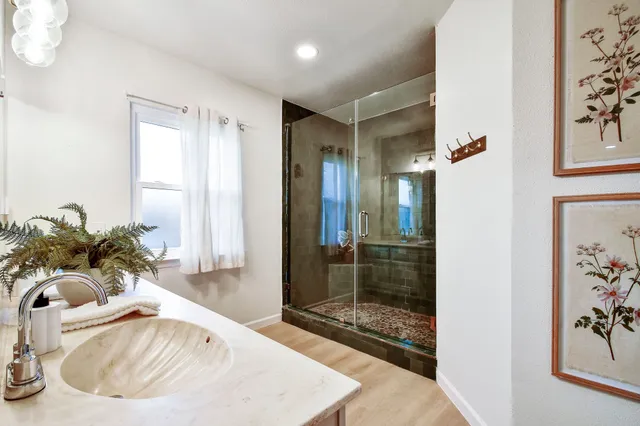 a white bath tub sitting next to a bathroom