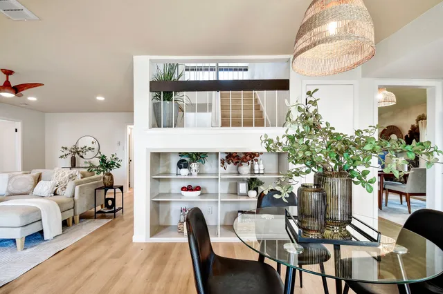 a view of a dining room with furniture and a potted plant