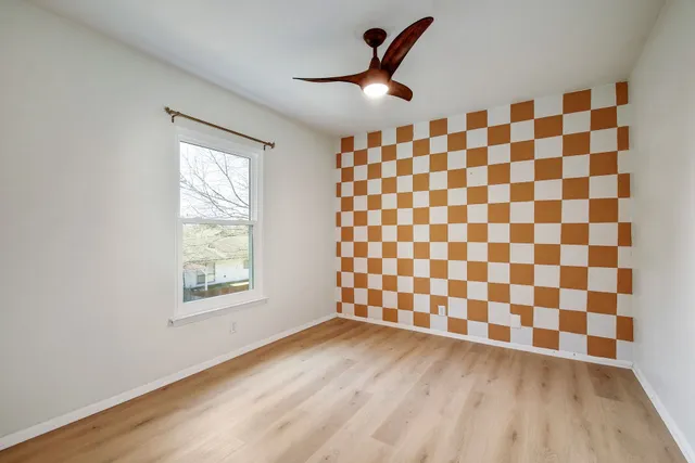 a view of a livingroom with wooden floor and a black white checkered floor