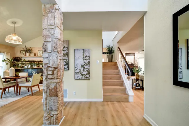 a view of a livingroom with wooden floor and furniture